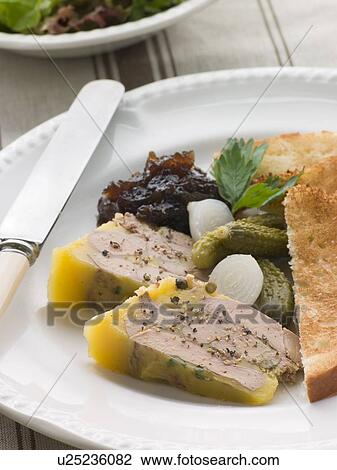 Stock Image - Pressing of Foie Gras and Green Peppercorns with Cornichons Brioche and Onion Confit. Fotosearch