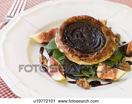 Stock Image - Red Onion Tarte Tatin with Walnuts Figs and Red Wine Syrup. Fotosearch