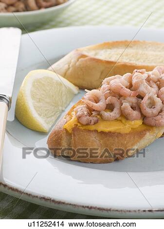 Picture - Rouille and Brown Shrimps on Toasted Baguette. Fotosearch