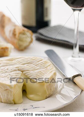 Round of camembert cheese with French stick and Red Wine View Large Photo Image Stock Photo - Round of camembert cheese with French stick and Red Wine. Fotosearch