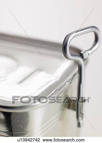 Stock Image - Close up of opener on tin can. Fotosearch