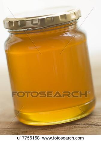 Jar of honey and spoon View Large Photo Image Stock Photo - Jar of honey and spoon. Fotosearch