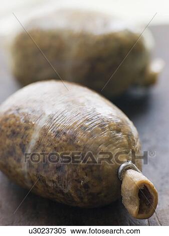 Stock Photography - Whole Haggis on a Chopping Board. Fotosearch