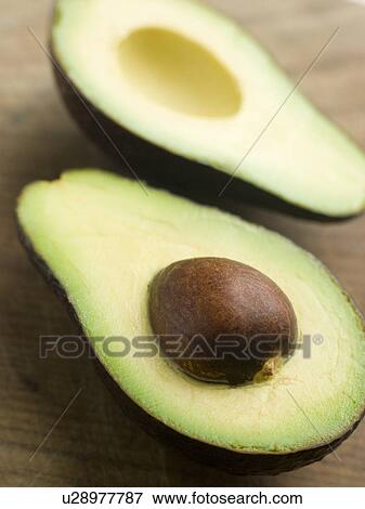 Halved avocado View Large Photo Image Stock Photo - Halved avocado. Fotosearch