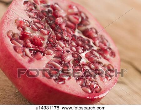 Stock Photo - Halved fresh pommegranate. Fotosearch