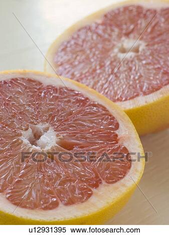 Stock Photography - Halved pink grapefruit. Fotosearch