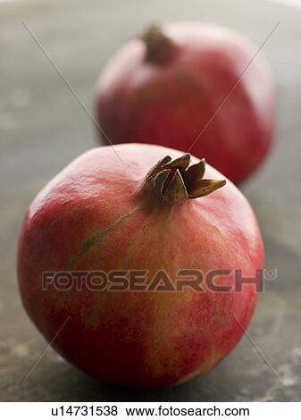 Two whole pommegranates View Large Photo Image Stock Photo - Two whole pommegranates. Fotosearch
