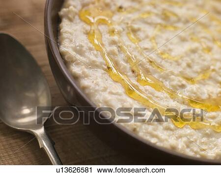Stock Image - Bowl of Porridge with Golden Syrup. Fotosearch