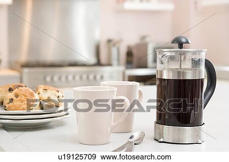 Coffee pot on kitchen counter with scones View Large Photo Image Stock Photo - Coffee pot on kitchen counter with scones. Fotosearch