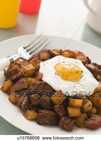 Corned Beef Hash With a Fried Egg and Black Pepper View Large Photo Image Stock Photo - Corned Beef Hash With a Fried Egg and Black Pepper. Fotosearch