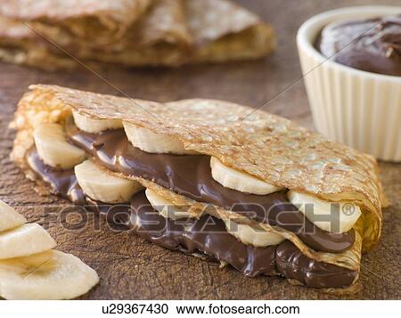 Stock Image - Crepes filled with Banana and Chocolate Hazelnut Spread. Fotosearch