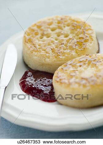 Stock Image - Crumpets with Butter and Jam. Fotosearch