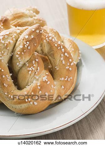 Large Salted Pretzel and a Glass of Beer View Large Photo Image Stock Image - Large Salted Pretzel and a Glass of Beer. Fotosearch