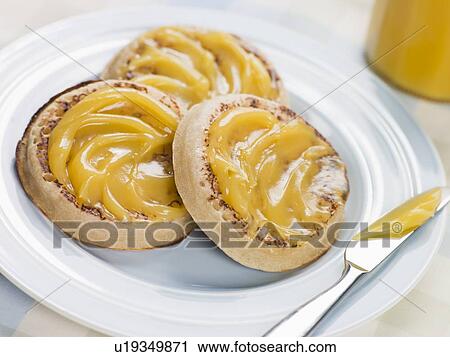 Stock Image - Lemon Curd Crumpets. Fotosearch