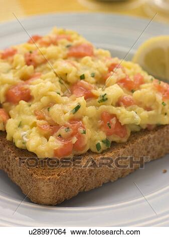 Picture - Scrambled Egg and Smoked Salmon on Brown Toast. Fotosearch
