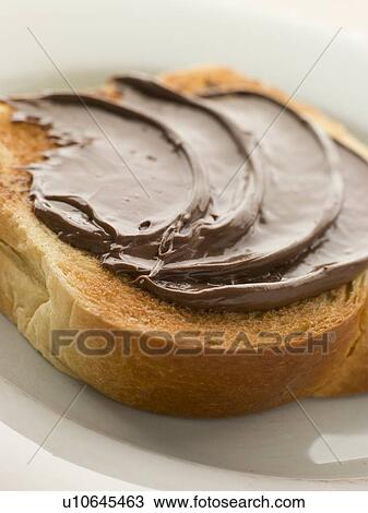 Stock Image - Slice of Toasted brioche with Chocolate Spread. Fotosearch