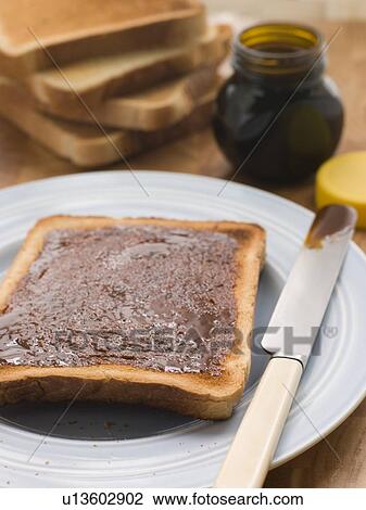 Stock Image - Slices of Toast with Yeast Extract Spread. Fotosearch