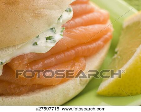 Stock Photography - Smoked Salmon and Cream Cheese Bagel with a wedge of Lemon. Fotosearch