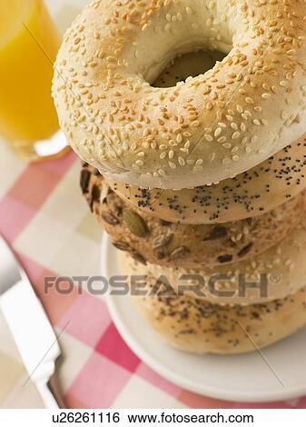 Stack of Seeded Bagels with a Glass of Orange Juice View Large Photo Image Stock Photograph - Stack of Seeded Bagels with a Glass of Orange Juice. Fotosearch