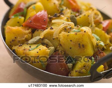 Stock Image - Bombay Aloo - Curried Potatoes. Fotosearch