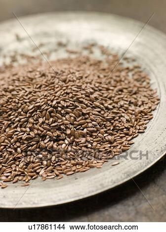 Picture - Brown Linseed on a Pewter Plate. Fotosearch