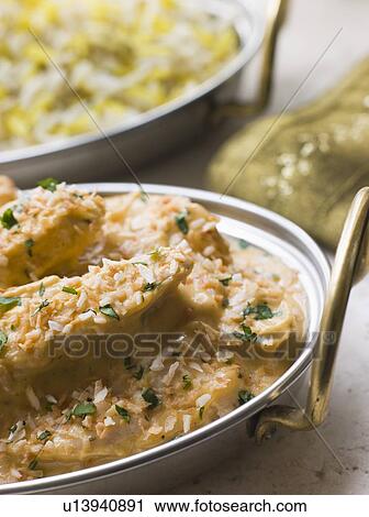 Stock Image - Dish of Chicken Pasanda with Pilau. Fotosearch
