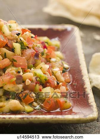 Stock Image - Dish of Cucumber with Papadoms. Fotosearch
