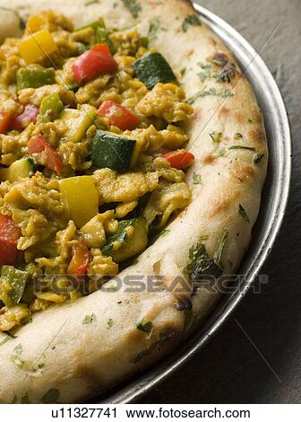 Stock Image - Indian Scrambled Eggs and Naan Bread. Fotosearch