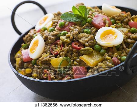Stock Photograph - Karahi Dish with Punjabi Keema Mattar and Quail Eggs. Fotosearch