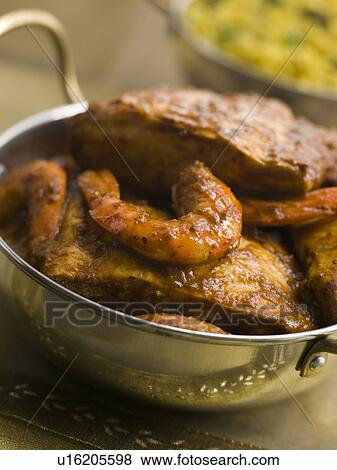 Stock Photo - Madras Fish Curry with Vegetable Pilau rice. Fotosearch