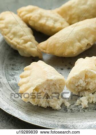 Stock Photo - Plate of Coconut Karanji. Fotosearch