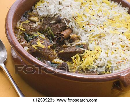 Stock Photography - Pot of Lamb Biryani with a spoon. Fotosearch