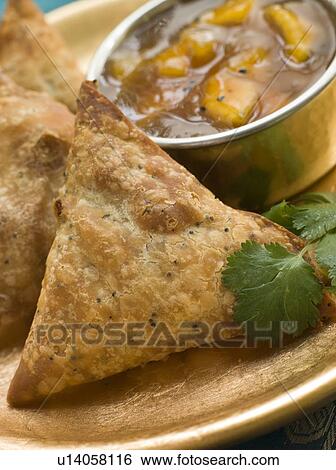 Stock Photograph - Vegetable Samosa with Mango Chutney. Fotosearch