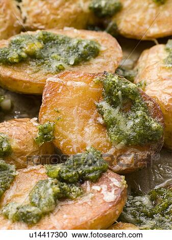 Stock Image - Baby Potatoes roasted with Pesto. Fotosearch