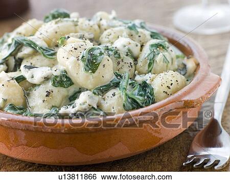 Stock Photograph - Dish of Gnocchi and Spinach with a Gorgonzola Cream Sauce. Fotosearch