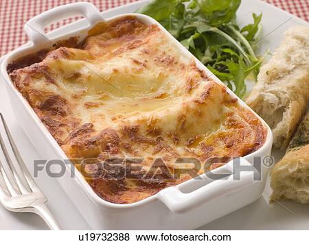 Dish of Lasgane with Salad Leaves and Italian Bread View Large Photo Image Stock Photo - Dish of Lasgane with Salad Leaves and Italian Bread. Fotosearch
