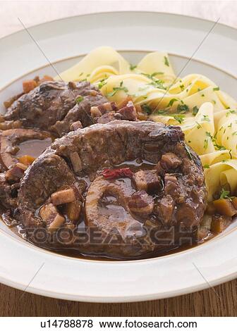 Osso Bucco alla Milanaise with Herb Tagliatelle View Large Photo Image Stock Photo - Osso Bucco alla Milanaise with Herb Tagliatelle. Fotosearch