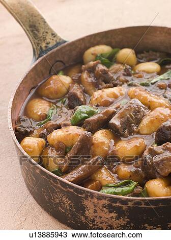 Oxtail Braised in Red Wine with Basil Gnocchi View Large Photo Image Stock Image - Oxtail Braised in Red Wine with Basil Gnocchi. Fotosearch