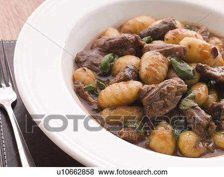 Stock Photo - Oxtail Braised in Red Wine with Basil Gnocchi. Fotosearch
