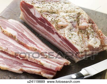 Stock Photo - Piece of Pancetta and Slices. Fotosearch