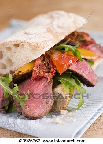 Stock Image - Sirloin Steak and Roasted Pepper Ciabatta Sandwich. Fotosearch