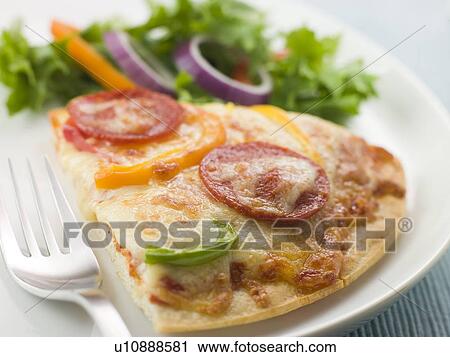 Stock Image - Slice of Pepperoni and Pepper Pizza with Salad. Fotosearch