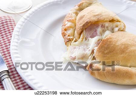 Stock Photo - Spinach Tomato and Goats Cheese Calzone. Fotosearch