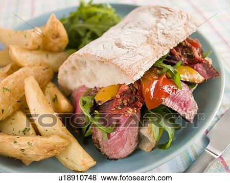 Steak and Roasted Pepper Ciabatta Sandwich with Spiced Potato Wedges View Large Photo Image Stock Photo - Steak and Roasted Pepper Ciabatta Sandwich with Spiced Potato Wedges. Fotosearch