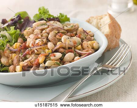 Stock Photography - Tuscan Bean Salad with Dressed Leaves and Crusty Bread. Fotosearch