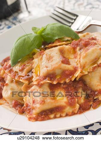 Stock Photo - Veal and Sage Ravioli with Tomato and Basil Sauce. Fotosearch