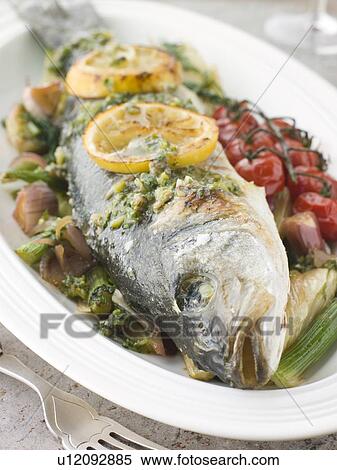 Whole Roasted Sea Bass with Fennel Lemon Cherry Vine Tomatoes and Salsa Verde View Large Photo Image Stock Photography - Whole Roasted Sea Bass with Fennel Lemon Cherry Vine Tomatoes and Salsa Verde. Fotosearch
