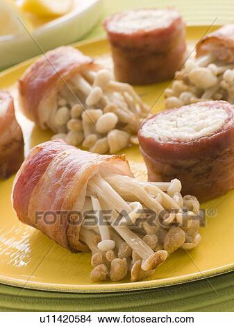 Picture - Enoki Mushrooms wrapped in Smoked Bacon. Fotosearch