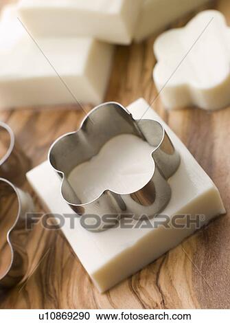 Stock Image - Firm Tofu on a Chopping Board. Fotosearch