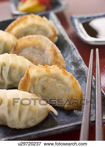 Stock Photo - Fried Pork and Shrimp Dumplings with Soy Sauce. Fotosearch